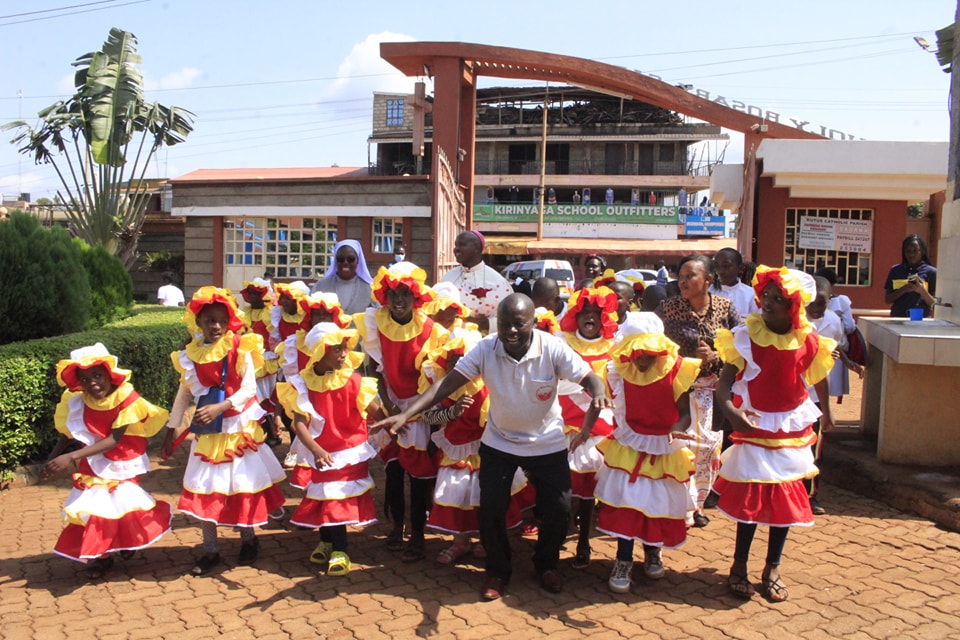 Children in traditional dance costumes during parish celebration