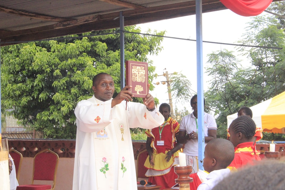 Fr. Dennis teaching and leading worship